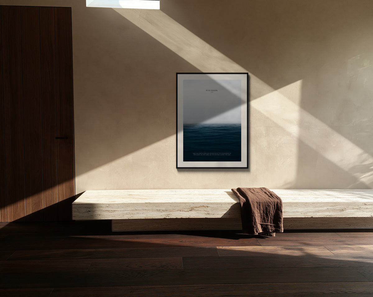 Framed sea print above a travertine bench