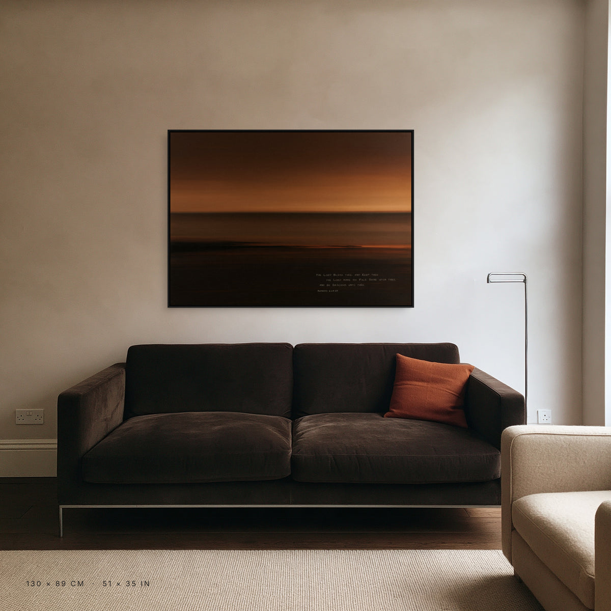 Amber canvas, 130 x 89 cm, black floating frame, above a sofa in a living room
